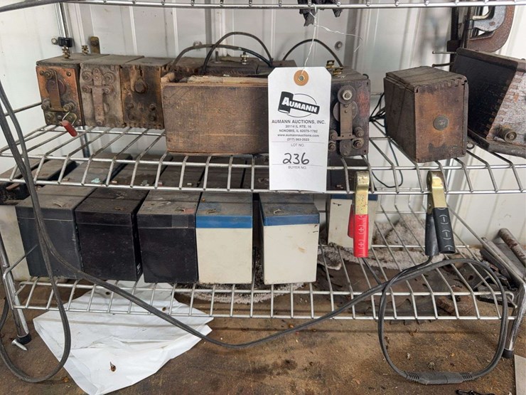 assorted-garage-shelf-contents-including-automotive-fluids,-batteries,-charger,-and-accessories-image-5