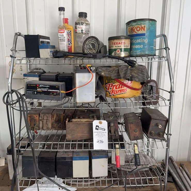 Assorted Garage Shelf Contents Including Automotive Fluids, Batteries, Charger, and Accessories