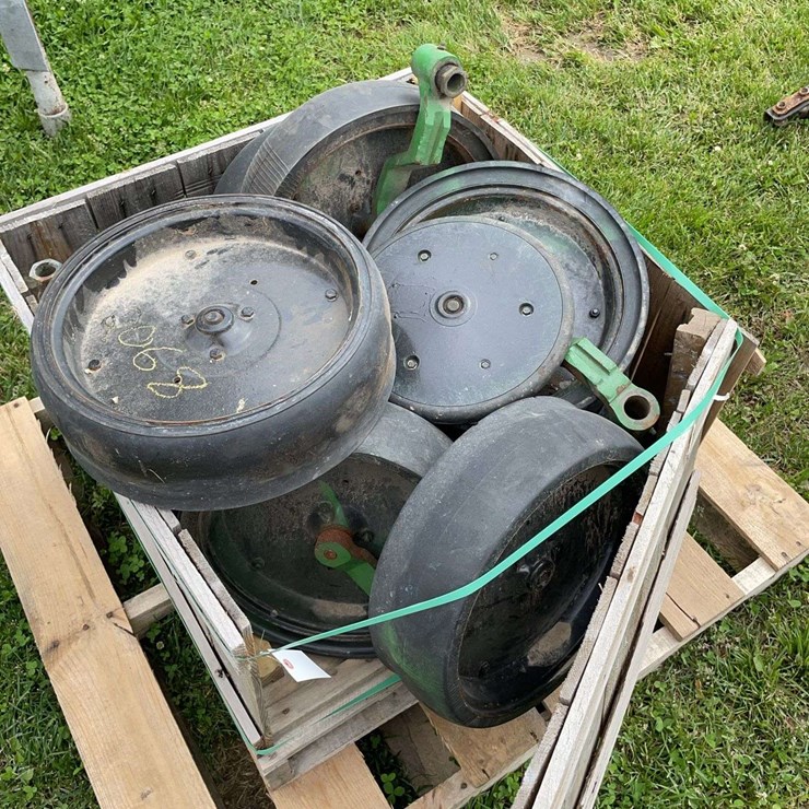 Pallet of planter press wheels off JD planter