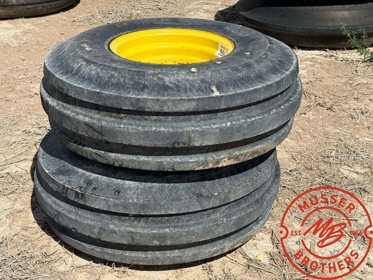 pair-of-11.00-16-triple-rib-tires-on-8-hole-wheels-image-1