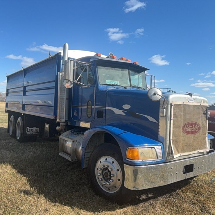1995 Peterbuilt tandem twin screw grain truck, 375 Conventional, equipped with 2010  21’ Load Line box and hoist, swing out gate, roll tarp, rear controls, M-11 Cummins motor, 9 speed, 755,400 miles