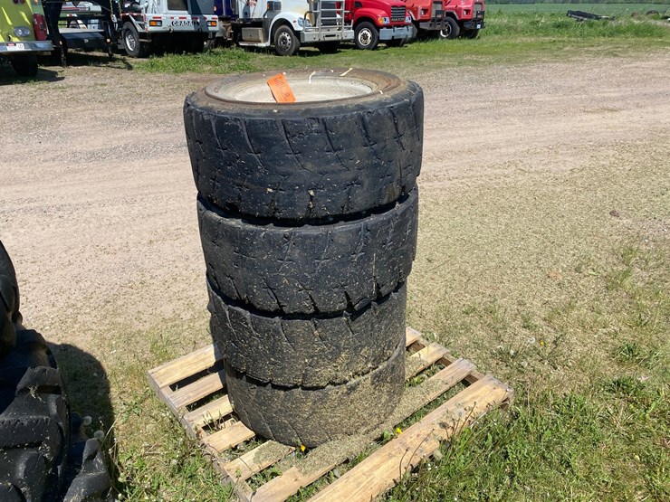 #7067-•-(4)-12-16.5-skid-steer-tires-on-rims-(deerbrook,-wi)-image-1