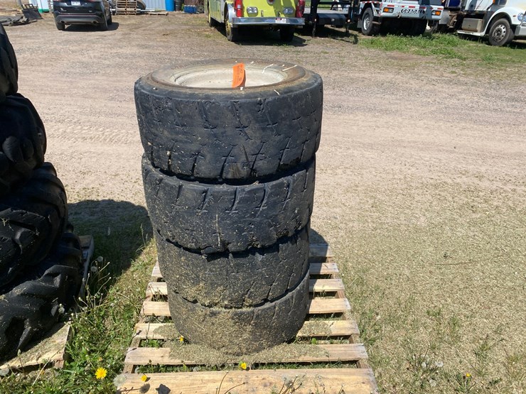#7067-•-(4)-12-16.5-skid-steer-tires-on-rims-(deerbrook,-wi)-image-2