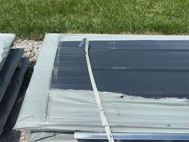 stack-of-black-corrugated-metal-roofing-panels-image-2