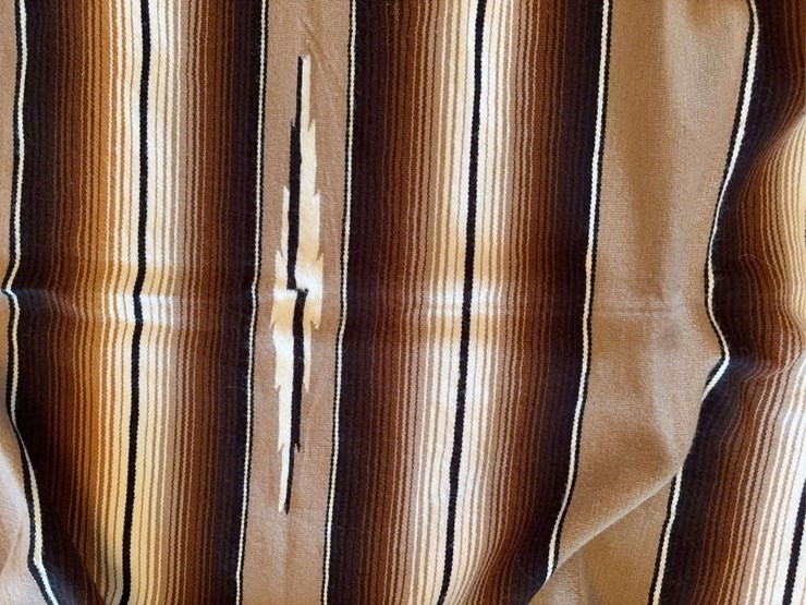 striped-woven-textile-blanket-with-fringed-edges-image-4