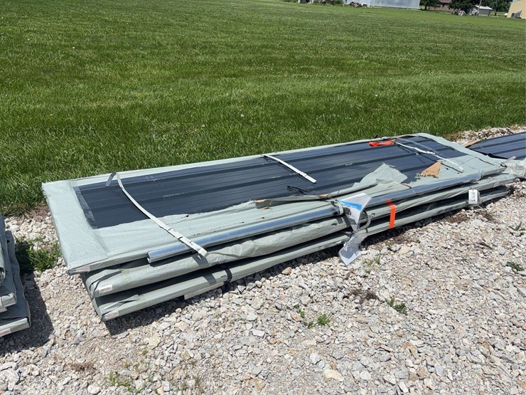 stack-of-black-corrugated-metal-roofing-panels-image-1
