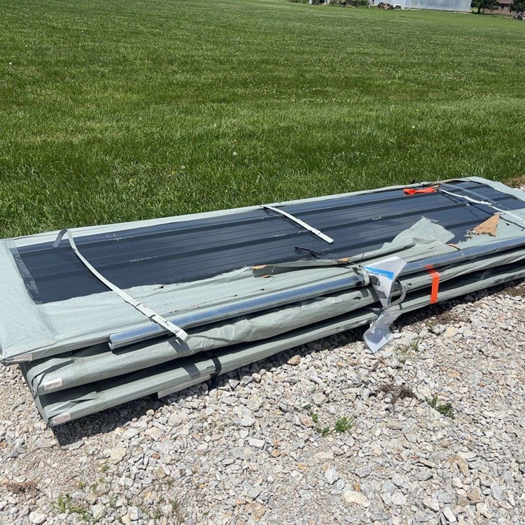 Stack of Black Corrugated Metal Roofing Panels