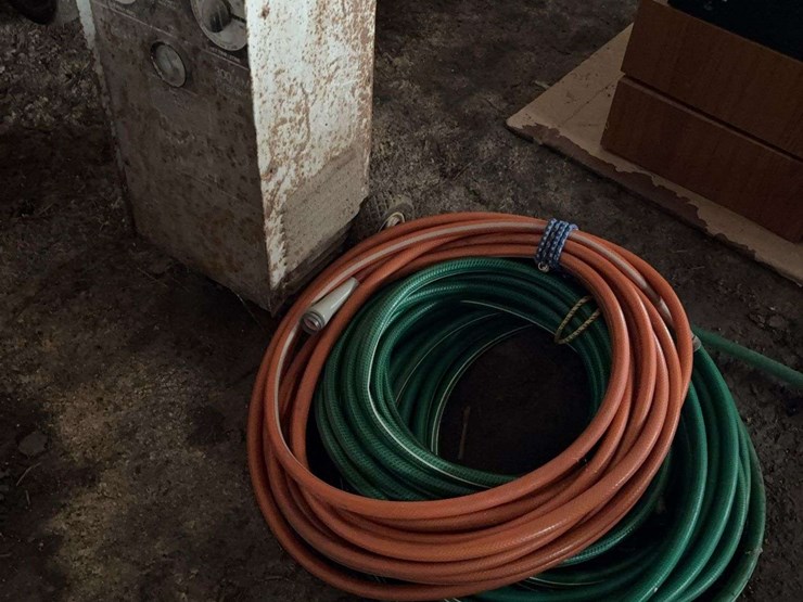 wheeled-battery-charger-and-assorted-garden-hoses-image-1