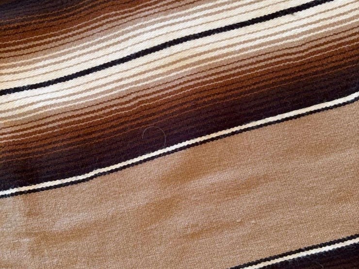 striped-woven-textile-blanket-with-fringed-edges-image-2
