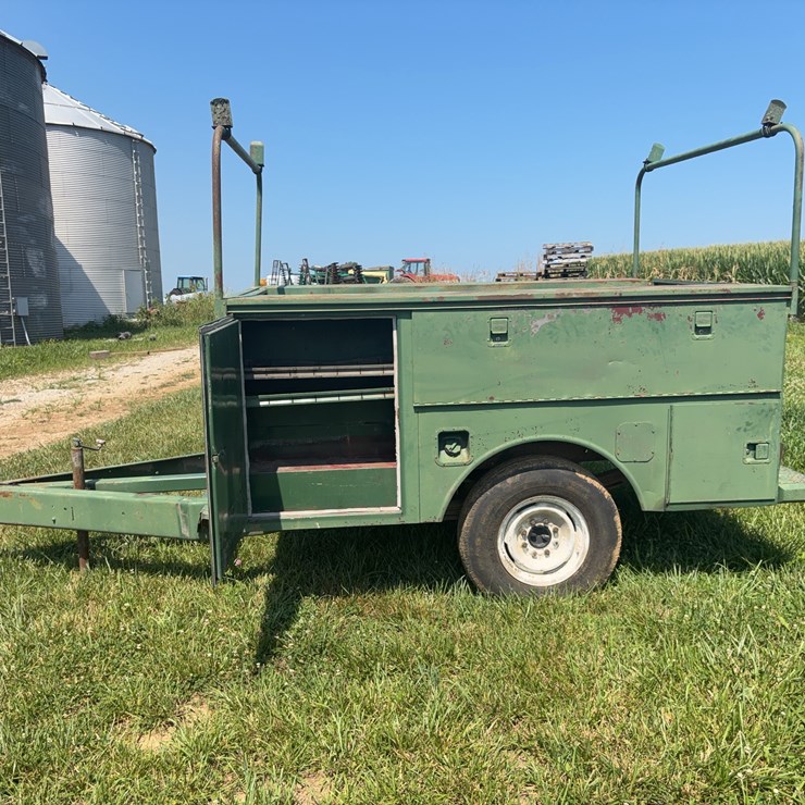 Utility bed tool box trailer with heavy axles.