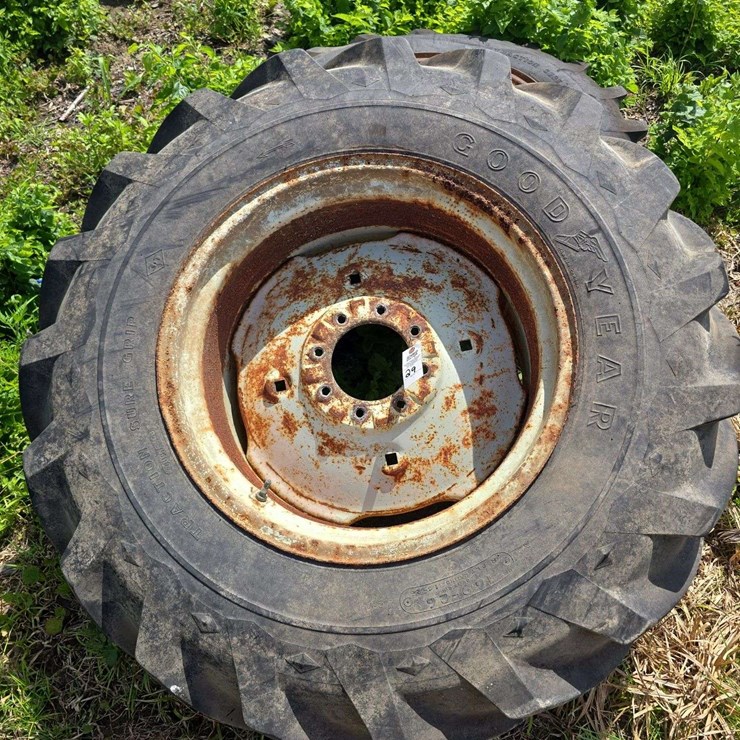 Pair of Good-Year 16.9-26 tires on 8 lug rims