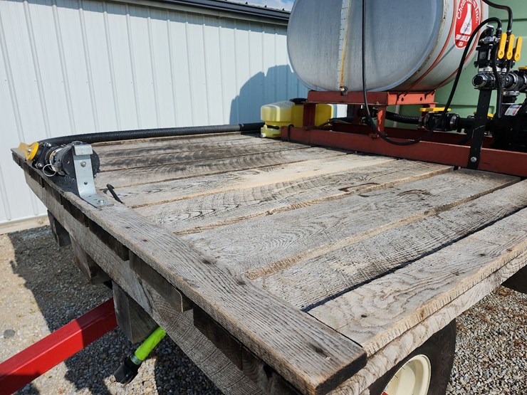 spray-wagon-on-unverferth-mccurdy-g12-running-gear-with-native-flat-rack-image-2