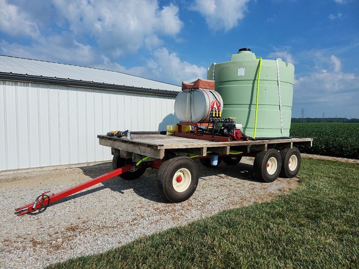 spray-wagon-on-unverferth-mccurdy-g12-running-gear-with-native-flat-rack-image-1