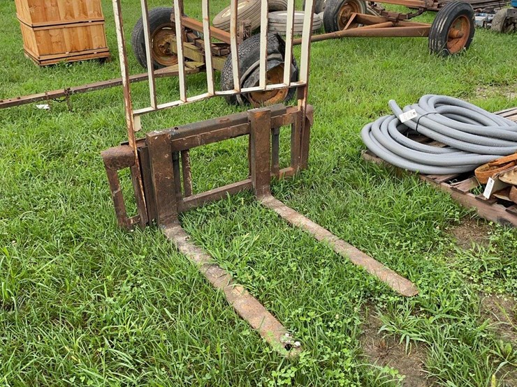 pallet-forks-for-skid-steer,-has-bent-frame-image-1