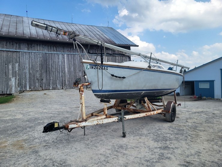 capri-sailboat-w/-single-axle-bumper-trailer-and-johnson-sailmaster-motor-image-1