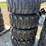 set-of-4-new-12-16.5-skid-steer-tires-on-rims-image-1