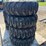 set-of-4-new-10-16.5-skid-steer-tires-on-rims-image-1