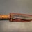 custom-stainless-steel-fixed-blade-knife-with-cream/red-striped-handle-image-1