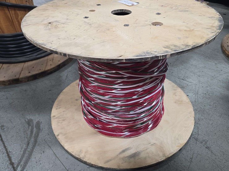 large-wooden-spool-with-cantinos-length-of-mulit-color-stranded-electrical-wire-with-red,-white,-black,-and-green-strands-image-1