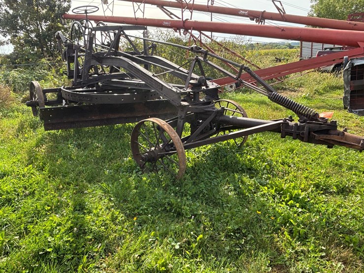 #1329-•-adam-leaning-steel-wheeled-grader-image-4