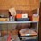 shop-contents-lot-with-metal-workbench,-hand-tools,-automotive-parts,-hardware,-and-signage-image-3