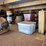 loft-storage-assortment-with-tractor-parts,-furniture,-and-containers-image-5