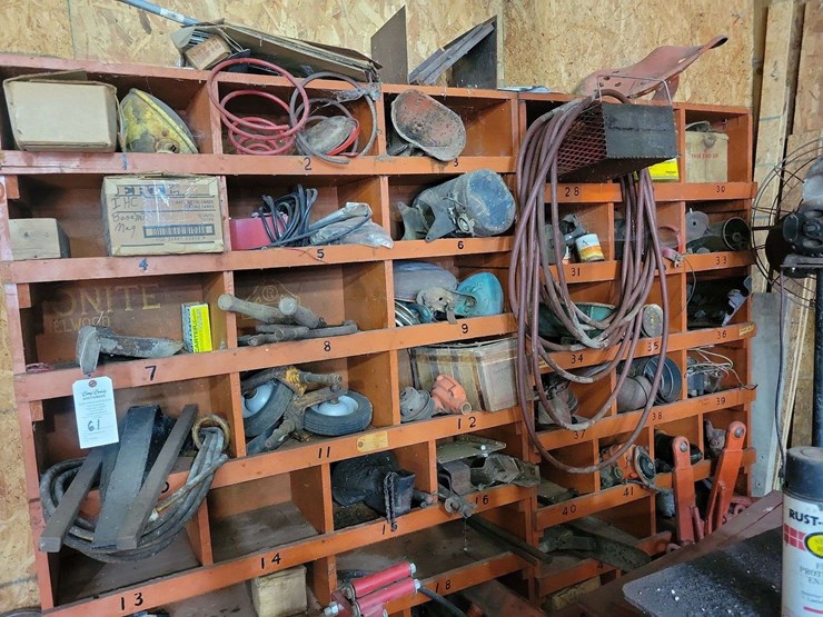 shop-storage-shelving-unit-with-contents-including-tractor-parts,-hoses,-and-hardware-image-1