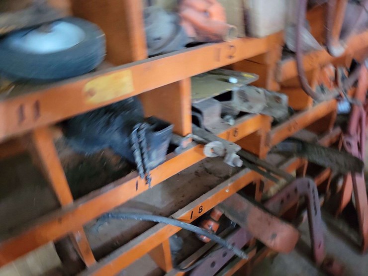 shop-storage-shelving-unit-with-contents-including-tractor-parts,-hoses,-and-hardware-image-3