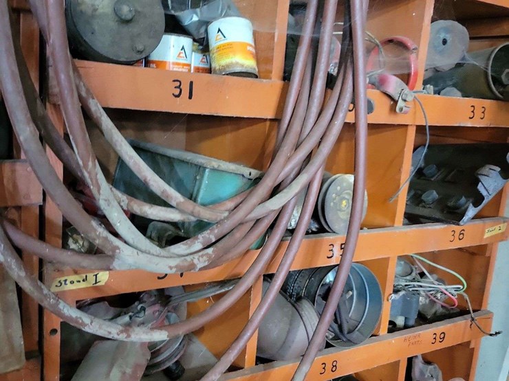 shop-storage-shelving-unit-with-contents-including-tractor-parts,-hoses,-and-hardware-image-5