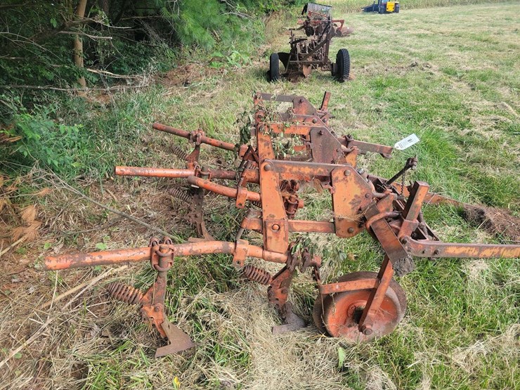 tractor-drawn-multi-row-cultivator-implement-with-metal-frame-and-ground-wheels-image-3