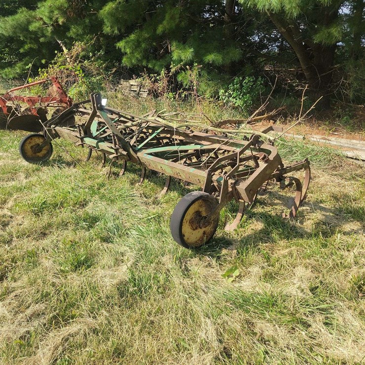 Green Farm Cultivator Implement with Tines and Gauge Wheels