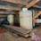 loft-storage-assortment-with-tractor-parts,-furniture,-and-containers-image-3