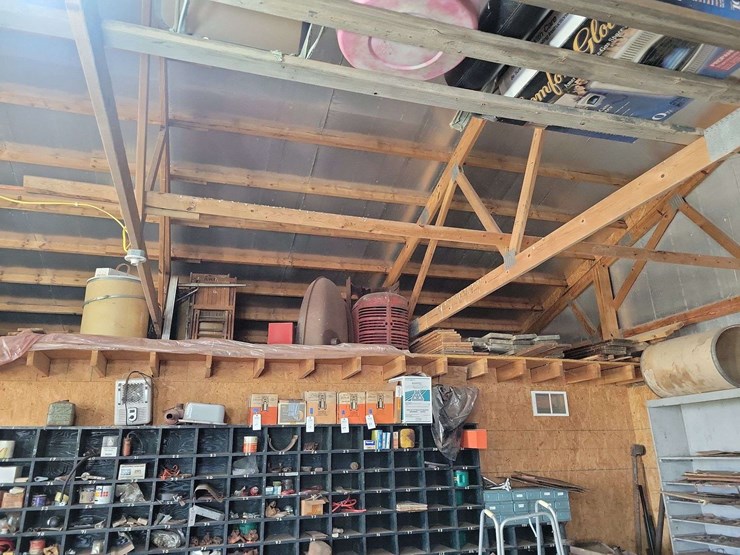 loft-storage-assortment-with-tractor-parts,-furniture,-and-containers-image-1