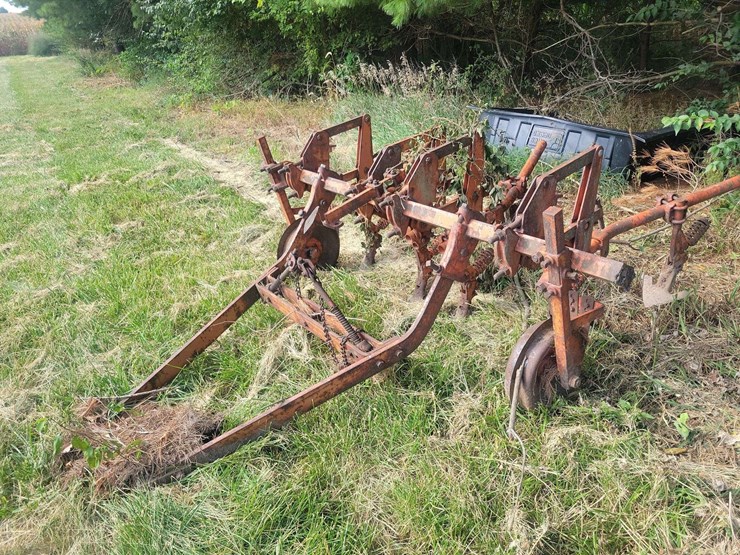 tractor-drawn-multi-row-cultivator-implement-with-metal-frame-and-ground-wheels-image-1