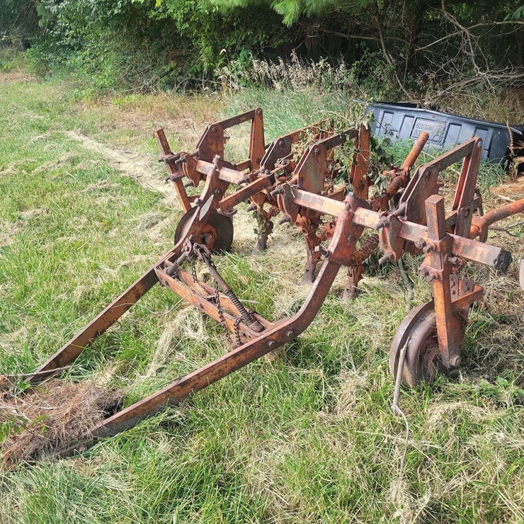 Tractor-Drawn Multi-Row Cultivator Implement with Metal Frame and Ground Wheels