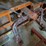 shop-storage-shelving-unit-with-contents-including-tractor-parts,-hoses,-and-hardware-image-4
