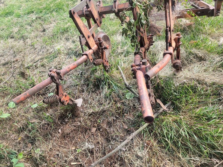 tractor-drawn-multi-row-cultivator-implement-with-metal-frame-and-ground-wheels-image-4