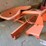 orange-painted-cast-metal-tractor-seat-with-spring-suspension-mount-image-1