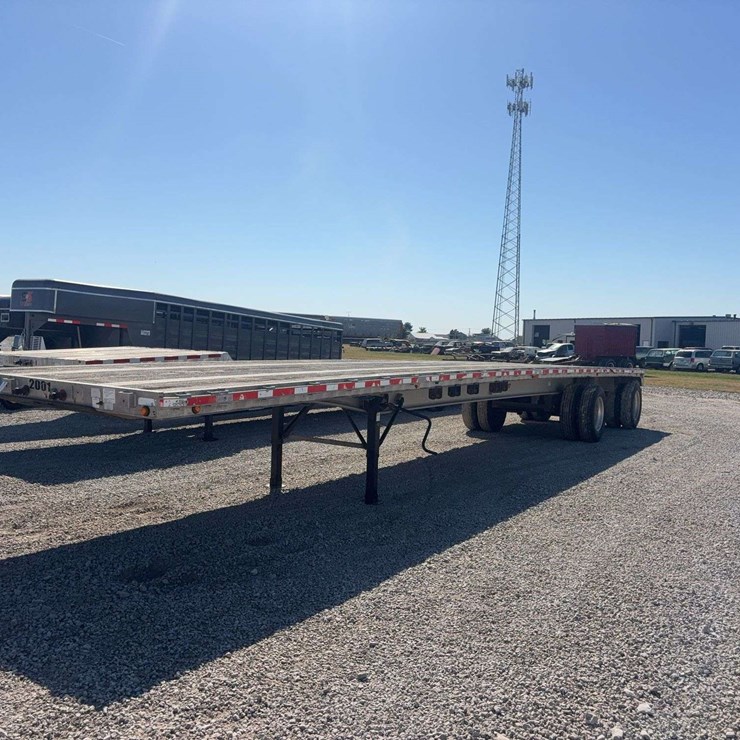 2006 East 48t flat deck semi trailer, spread axle (120"), All axles: 21,200lbs, 11R24.5 tires, steel coil supports, VIN# 1E1H5Y2857RJ40074
